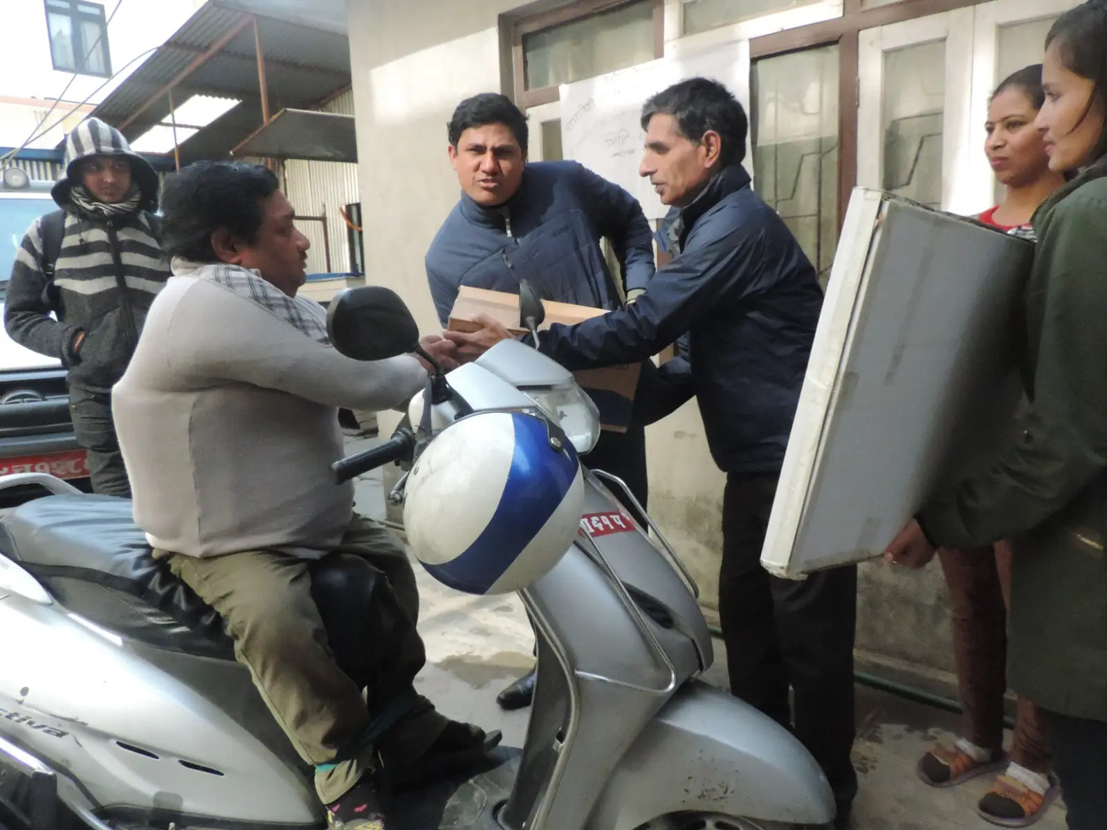 HomeNet Nepal handing over livelihood tools to a person with disability